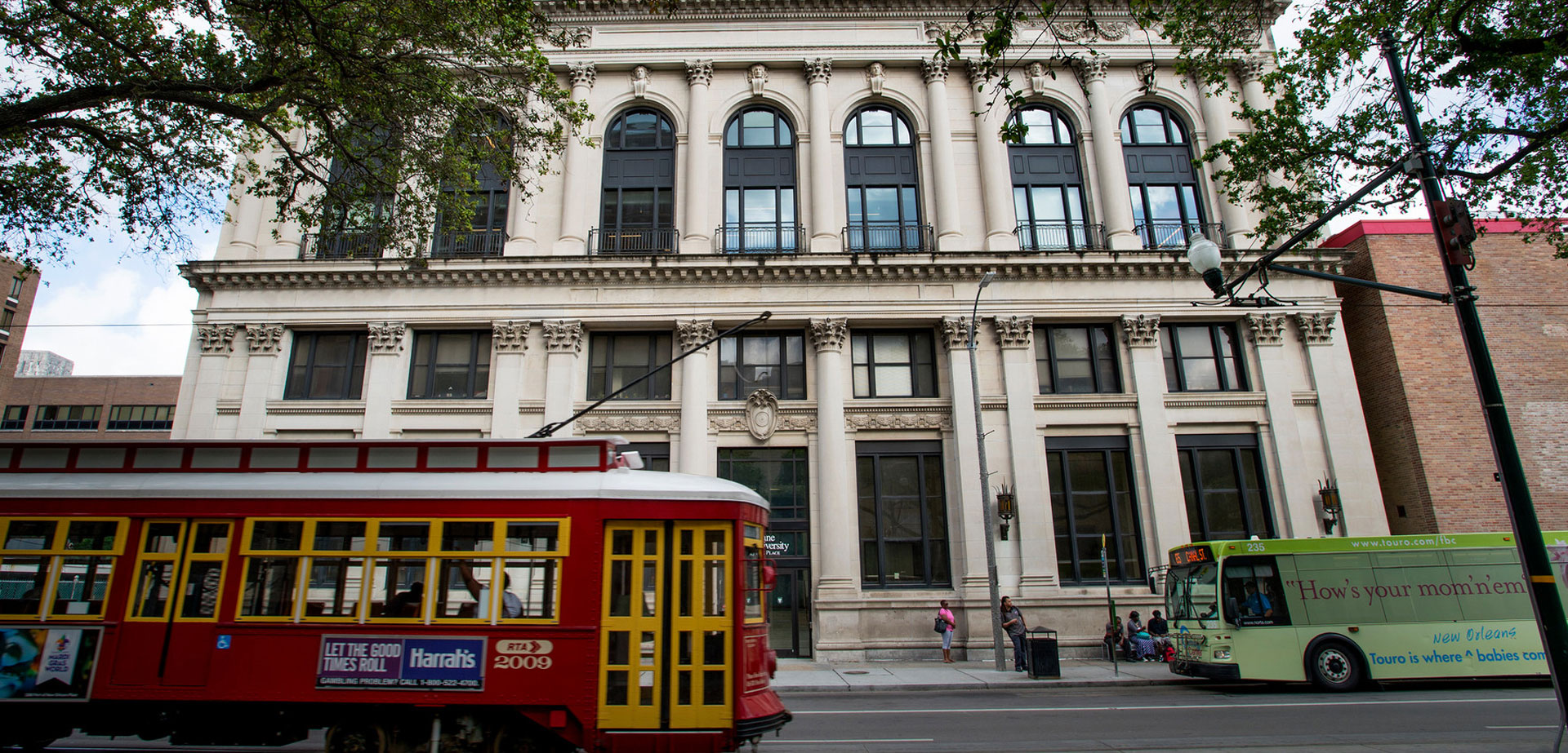 School of Social Work building with red streetcar passing by